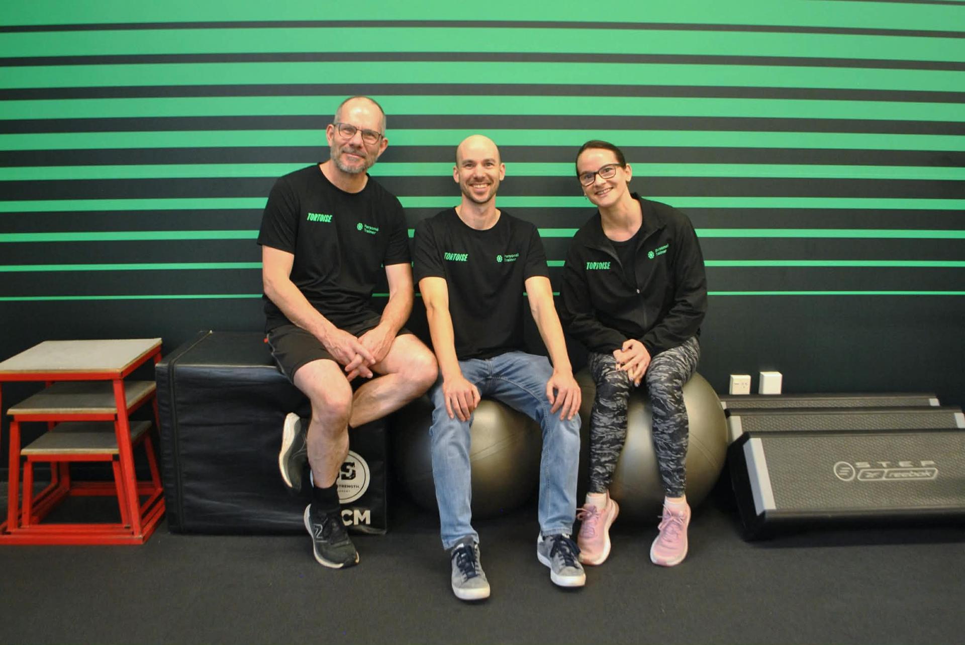 Anthony, Jesse, and Maddy Cooke — founders of Tortoise — in the gym