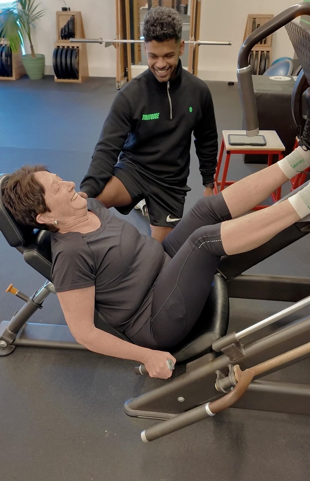 A Tortoise personal trainer working with a member on the leg press